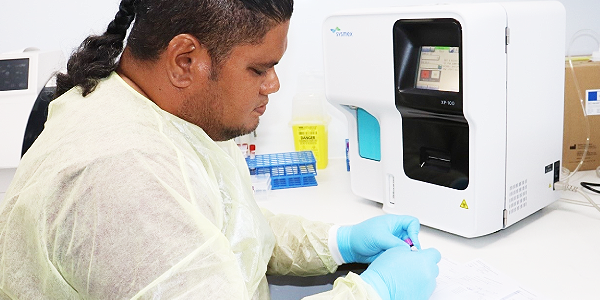 HGH Manager Lab Technician Mr. Solomon Soakai writing patients tests results.