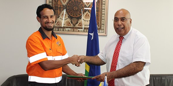 General Manager of SkyEye, Solomon Chant, shake hands with the Permanent Secretary of the Ministry of Foreign Affairs and External Trade, Colin Beck, after the renewal of their contract yesterday. Photo by MFAET