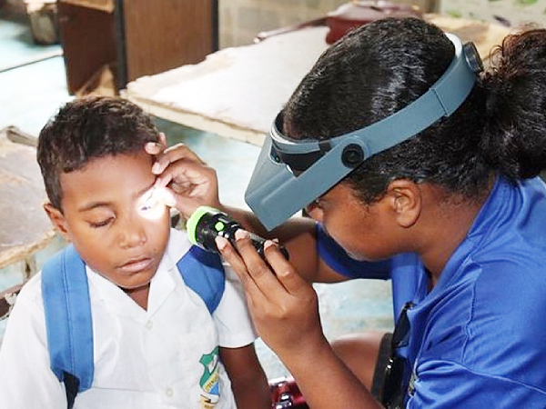 A MHMS National NTD Programme staff from Honiara during a Trachoma screening at a school in the Central Islands Province.