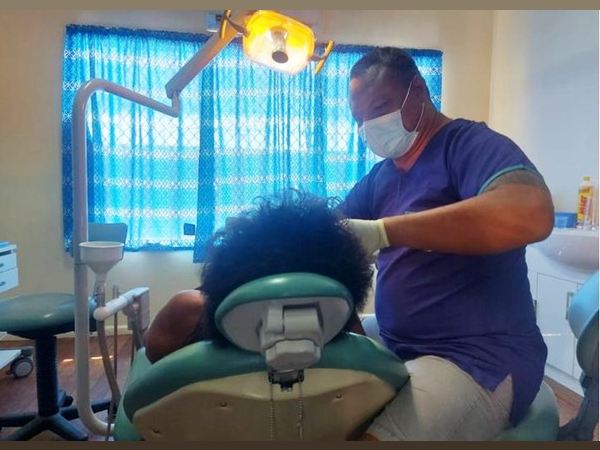 A dentist attending to a dental patient.