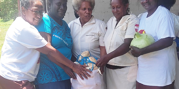 Dorcas ladies with a donated bag of potatoes.