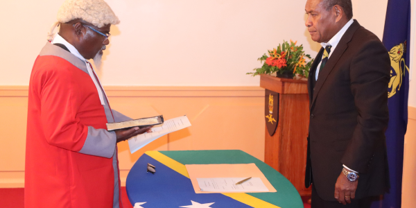 Justice Ronald Bei Talasasa takes his Oath before the Acting Governor General Sir Albert Palmer at Government House