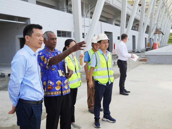 Secretary to Prime Minister and Chairman of the Pacific Games 2023 National Hosting Authourity, Dr Jimmy Rodgers and China Civil Engineering Construction Company (CCECC) CCECC Team leader, Huang Peng, with CCECC staff having a brief view of the national stadium project yesterday. Photo by CHARLES KADAMANA.
