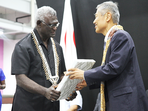The Japanese Ambassador, Miwa Yoshiaki, right, presenting a gift to Prime Minister Sogavare.