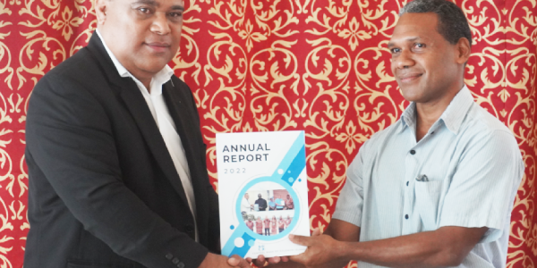 CBSI Governor Dr. Luke Forau (L) with an official from the Ministry of Finance & Treasury with a copy of the CBSI 2022 Annual Report, launched on Thursday. Photo, Charles Kadamana.