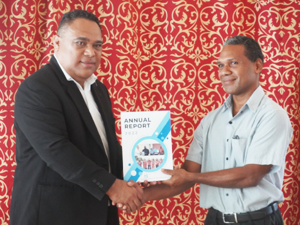 CBSI Governor Dr. Luke Forau (L) with an official from the Ministry of Finance & Treasury with a copy of the CBSI 2022 Annual Report, launched on Thursday. Photo, Charles Kadamana.