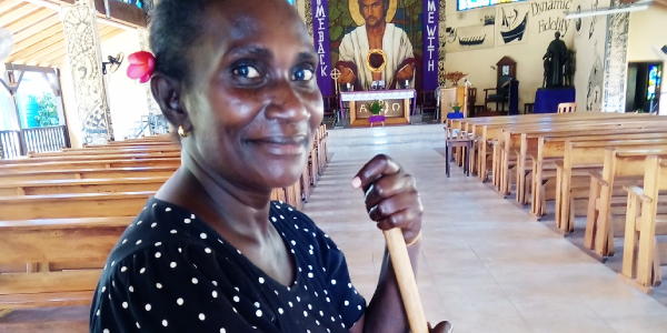 Mirriam Kabaloka very busy to clean up the church on Wednesday to prepare for this Easter weekend