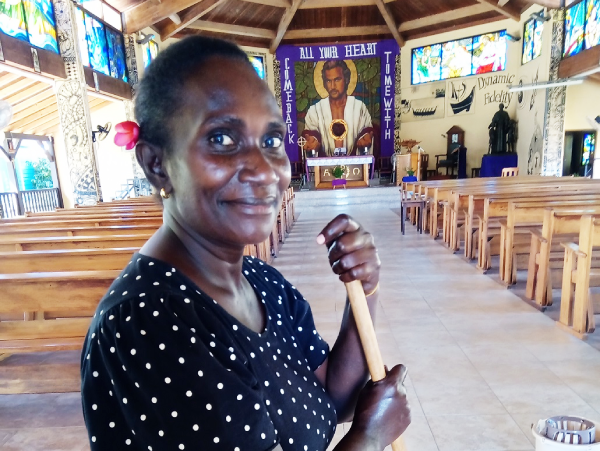 Mirriam Kabaloka very busy to clean up the church on Wednesday to prepare for this Easter weekend