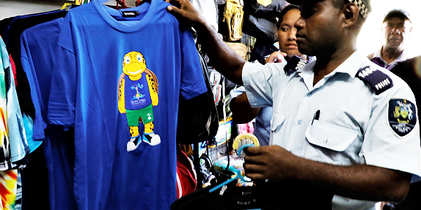Police confiscating illegal sale of Pacific Games merchandise. Photo GOC Media.