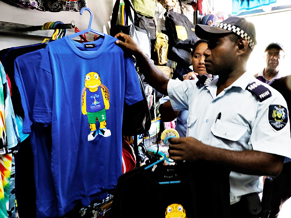 Police confiscating illegal sale of Pacific Games merchandise. Photo GOC Media.