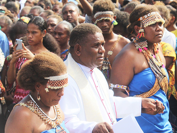 Women relatives of Bishop Bebeu dressed in traditional Lau costume escort him into the Fiu Cathedral church. Picture by Wilson Saeni.