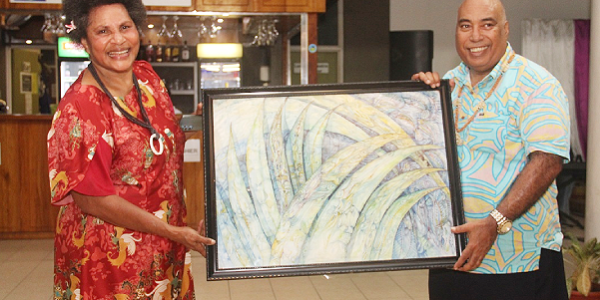 Chair of the Papua New Guinea delegation, Magdalene Moi-He presenting a gift to the Permanent Secretary of the Ministry of Foreign Affairs and External Trade, Colin Beck. Photo, MFAET.