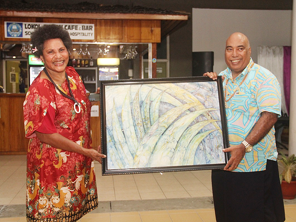 Chair of the Papua New Guinea delegation, Magdalene Moi-He presenting a gift to the Permanent Secretary of the Ministry of Foreign Affairs and External Trade, Colin Beck. Photo, MFAET.