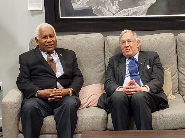 Sir David briefed by a UK Government Official on arrival at Heathrow Airport on Monday 1st of May, 2023.