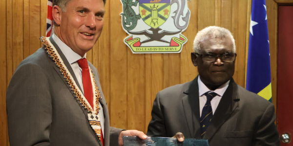 DPM Marles presenting a gift to PM Sogavare.