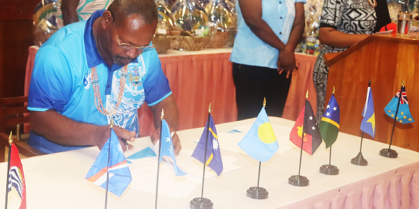 Fisheries Minister Nestor Ghiro signs the PNA Communique. Photo, Ministry of Fisheries.