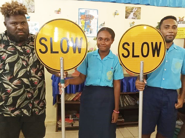 Florence Young Christian School students with the ‘Slow’ signages.