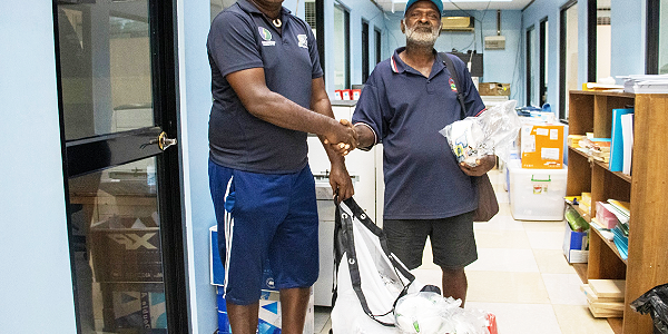 SIFF Youth Development Officer Eddie Rukumana hands over the equipment to Arosi caretaker President Timothy Tariasi at the SIFF office. Photo, SIFF.