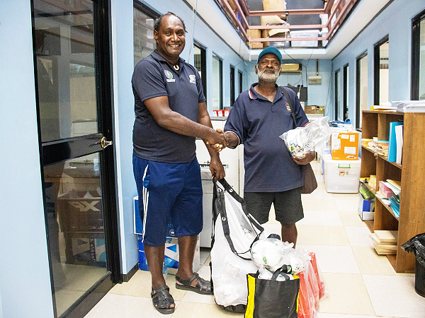 SIFF Youth Development Officer Eddie Rukumana hands over the equipment to Arosi caretaker President Timothy Tariasi at the SIFF office. Photo, SIFF.