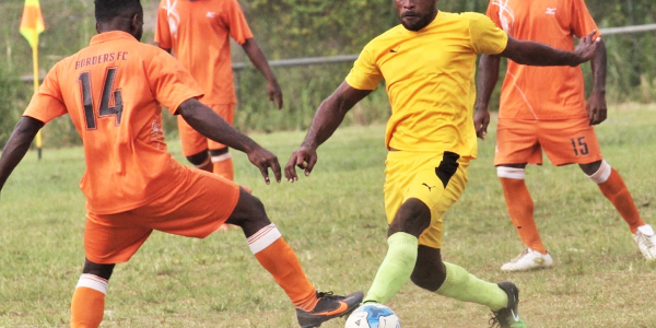 Southsiders player in yellow heavily marked by AG Fiu FC players in orange. Picture by Wilson Saeni.