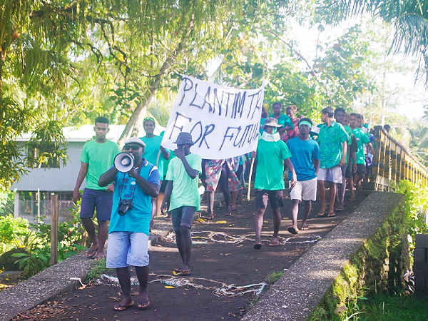 Students parading through the Ughele village by holding a banner stating, “Plant Trees for future.” Photo by Pana Paza.