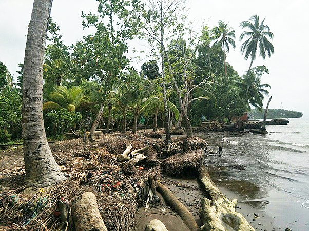 This coastline needs protection with massive sea-walls and sea-breakers because the beach also serves as a public road. Photo, Elron Dokese.