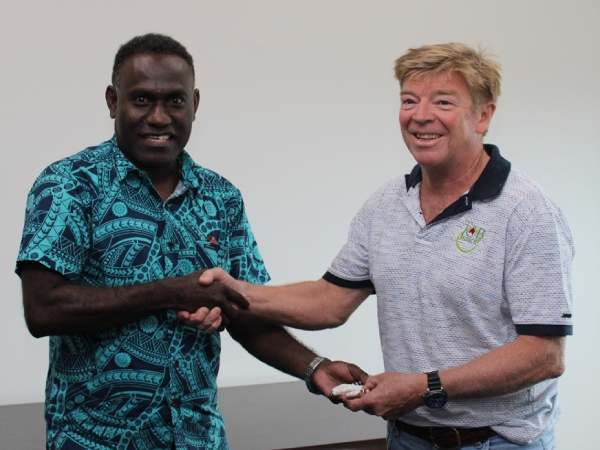 Trade Commissioner, Barrett Salato presenting a shell money gift to Andrew Coldbeck an Approved Employer of the Job Shop company.