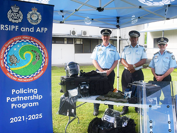 AFP-SI Commander, Heath Davies, RSIPF Commissioner Mangau and AFP Assistant Commissioner Ryan, with items donated to the RSIPF. Photo credit: RSIPF.