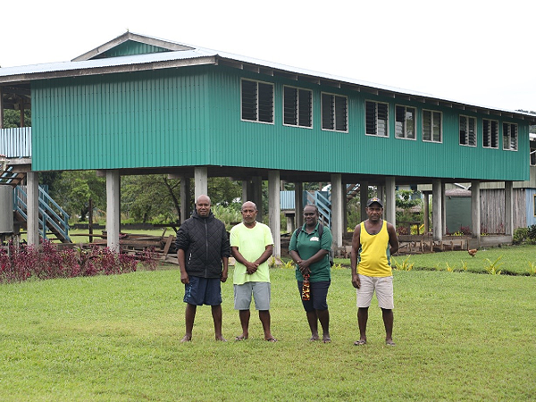 (L-R) Constituency Development Officer, Apollos Manegere, Head Teacher of Hirobuka School, Hugo Sagehebala, MRD Principal Monitoring & Evaluation Officer, Timoly Carter and Deputy Head Teacher of Hirobuka School, Etile Manehei standing in front of the Hirobuka School new permanent classroom co-funded by CDF. Photo: MRD.