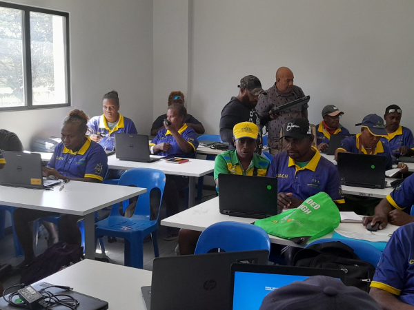 Coaches using the new laptops. Photo SINIS Media