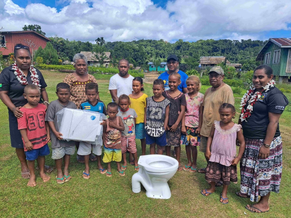 Laugwata community members and officers from Malaita Provincial Health Authority posing with the new toilet system during the handing over ceremony. Photo by Solomon Lofana.