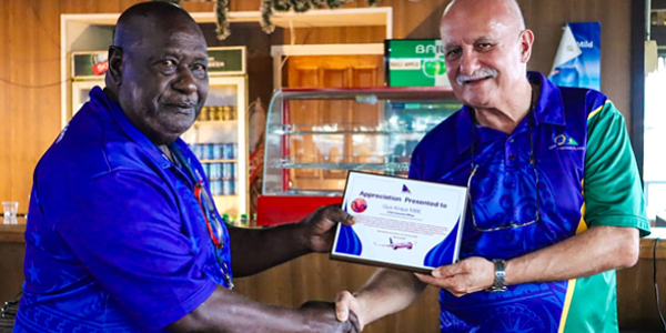 Kraus, right, awarded a certificate of appreciation by Solomon Airlines Manager Safety Systems and Security, Napoleon Pelapanda. Photo supplied.