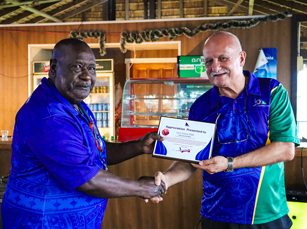 Kraus, right, awarded a certificate of appreciation by Solomon Airlines Manager Safety Systems and Security, Napoleon Pelapanda. Photo supplied.