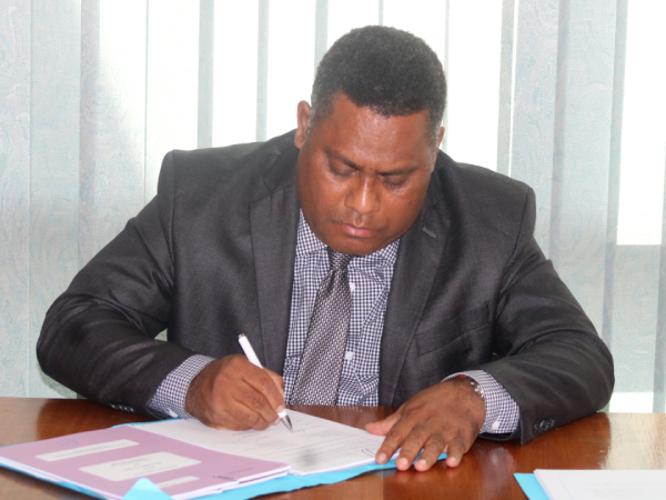Minister of National Planning and Development Coordination, Rexon Ramofafia, signing the grant Financing Agreement (1)
