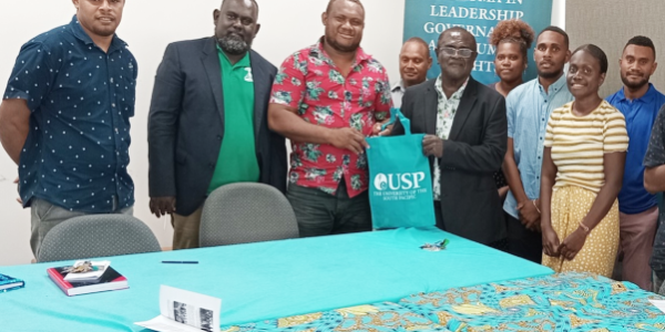 USPSA-SI President hands USP bag gift to the MWYCFA PS Dr Alependava as members of his delegation, MWYCFA’s Youth Division Director, Andrea Tipoki, Family Division Director, Jackson Tasa and HRM look on. Photo credit: USPSA-SI.