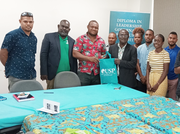 USPSA-SI President hands USP bag gift to the MWYCFA PS Dr Alependava as members of his delegation, MWYCFA’s Youth Division Director, Andrea Tipoki, Family Division Director, Jackson Tasa and HRM look on. Photo credit: USPSA-SI.