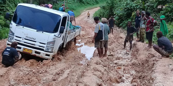 A three-ton truck stuck in the muddy road in East Malaita as passengers look on helplessly. File photo, Nick Atu.