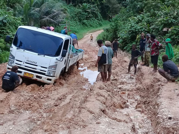 A three-ton truck stuck in the muddy road in East Malaita as passengers look on helplessly. File photo, Nick Atu.