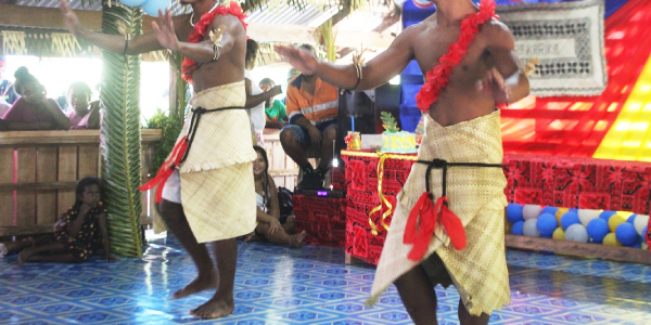 Two men performing a traditional dance item.