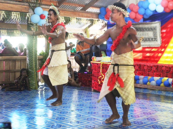 Two men performing a traditional dance item.