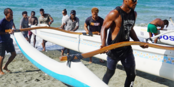 Solomon Islands Va’a Team carrying one of the canoes for the Sol2023 Pacific Games donated by the Australia Outrigger Clubs.