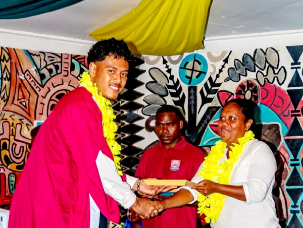 A graduating student receiving his certificate.
