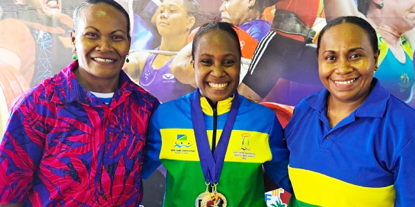 Gold Medalist Lorah Maelosi (centre) congratulated by Weightlifting Coaches Jenly Wini and Wendy Hale in Apia after receiving her medals. Photo credit: SINIS.