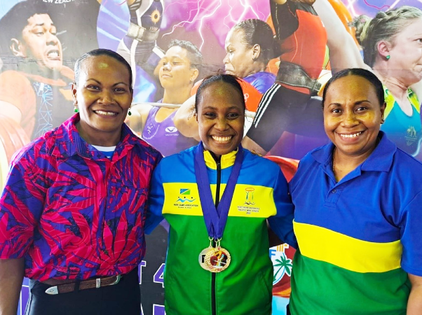 Gold Medalist Lorah Maelosi (centre) congratulated by Weightlifting Coaches Jenly Wini and Wendy Hale in Apia after receiving her medals. Photo credit: SINIS.