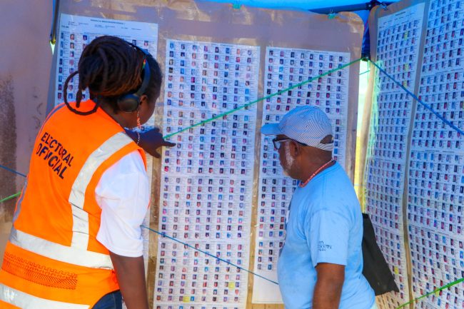 Central Honiara Election Official assisted a voter to check his name on the Provisional Voter List. Photo, MRD.