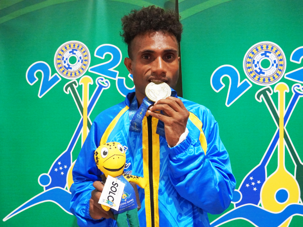 Isaac Pat Myrie with his historical Gold Medal. Photo by Lachlan Eddie Hoe.