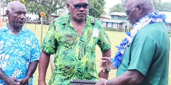 The caretaker PM receiving the Wards Development Plans from one of the four MPAs.