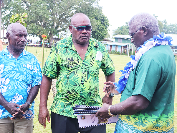 The caretaker PM receiving the Wards Development Plans from one of the four MPAs.