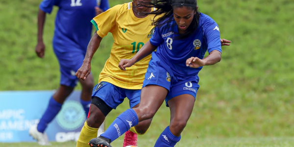 Solomon Islands Captain Ileen Pegi attempts to attack as Fiji player holds the ball. Photo by OFC MEDIA.