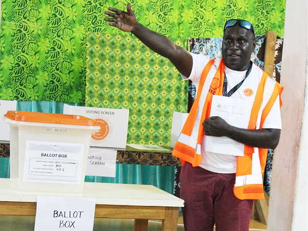 Election Manager Collin Potakana with the old ballot box and the legal instrument authorizing its reusage.